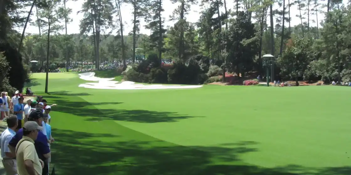 A wide fairway at Augusta National Golf Club, bordered by tall pines
