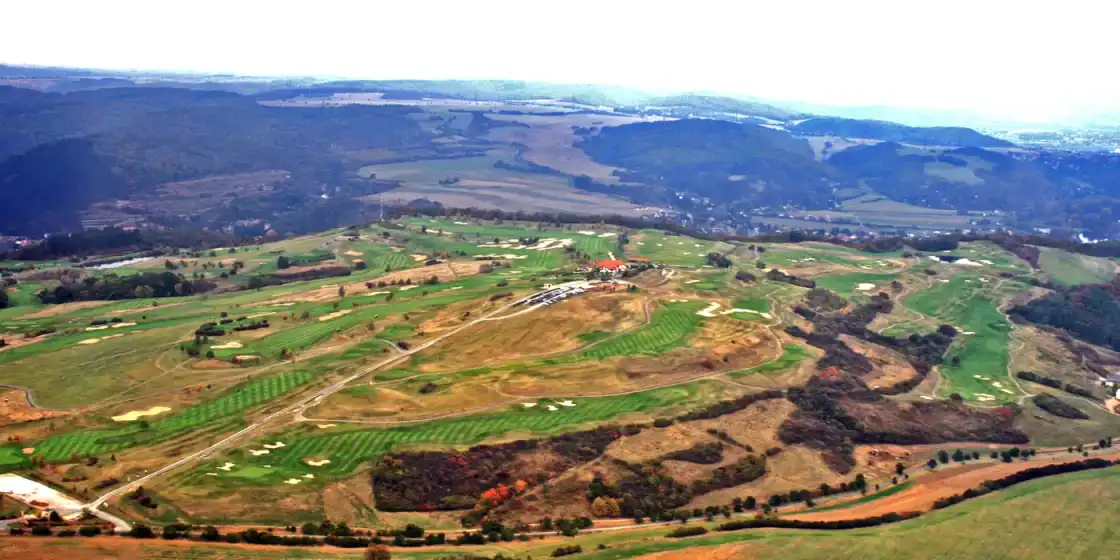 Aerial view of Golf Resort Karlštejn on its hillside above the Berounka valley
