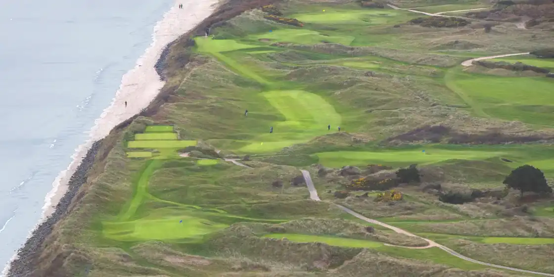 Aerial view of a selection of holes at Portmarnock Golf Club, Ireland; including 15th hole (left...
