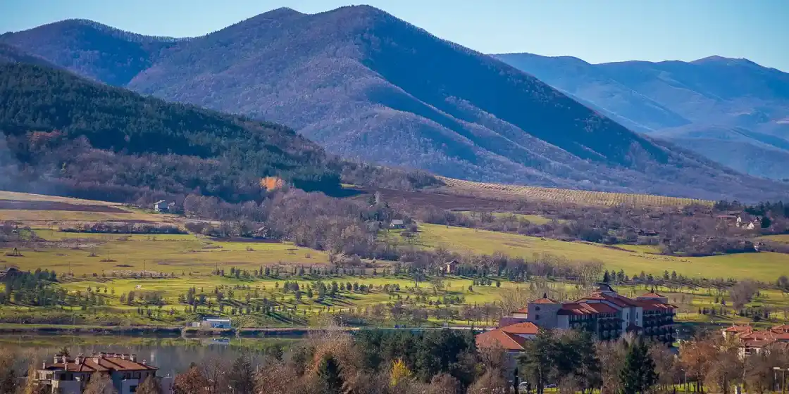 The course at Pravets with the resort hotel and the Balkan mountains behind