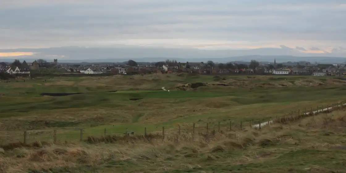 Prestwick's links among dunes and marram grass, with the town behind