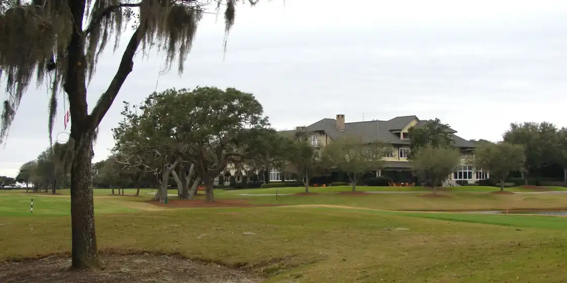 The Lodge at Sea Island seen across the Seaside Course, framed by live oaks